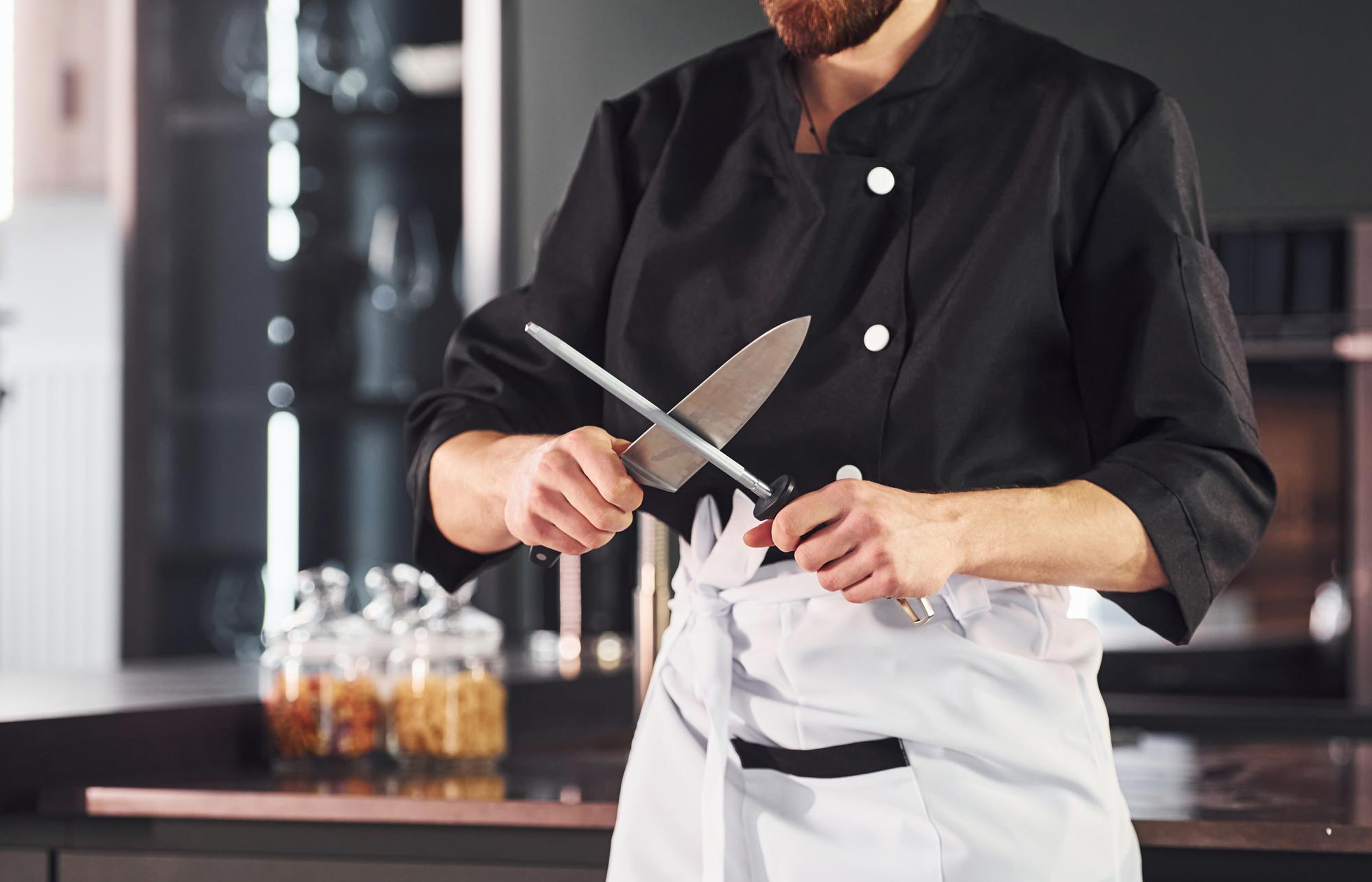 Workshop chef demonstrating technique to students