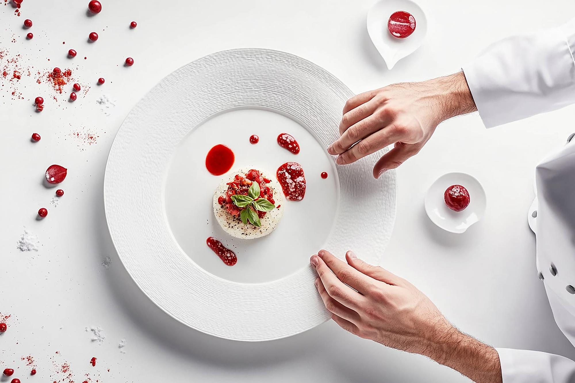 Chef plating elegant dish in workshop